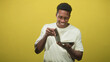 © Krakenimages.com - Man holding book and flipping pages with hands in studio while smiling and wearing a white tshirt, looking down at the text; joyful curiosity.