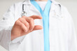 © Pixel-Shot - Male doctor holding something on light background, closeup