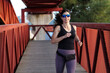 © FotoAndalucia - woman with sunglasses running on a bridge