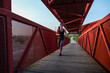 © FotoAndalucia - woman with sunglasses running on a bridge
