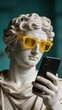 © olga_demina - A statue of a man with a modern twist, wearing yellow glasses and holding a phone, blending ancient and contemporary elements.