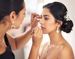 © Muk - A woman applies makeup to another woman's face