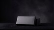 © Midnight - Empty black gift box resting on a dark surface for product design