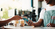 © peopleimages.com - Customer, hands and phone in coffee shop with POS machine, transaction and bill payment for hospitality. People, cashier and fintech in cafe with digital banking, purchase and contactless transfer.