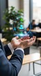 © MdNazim - Hands holding holographic network of connected user in office setting