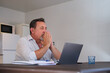 © Cristina Garcia - Mature man feeling stressed working remotely from home