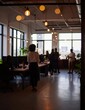 © Kimia - Modern Open Office Space with Natural Light and People Working.