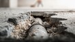 © TensorSpark - Exposed sewer line pipe in concrete slab showing crack and soil erosion, indicating pipe inspection, maintenance, and leak detection need.