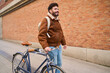 © Oscar - Urban man walking with bicycle enjoying city leisure