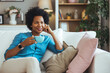 © Dragana Gordic - Relaxed Woman Enjoying Coffee on Comfortable Sofa at Home