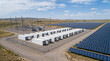 © H Visuals - BESS Battery Energy Storage Facility with Substation on Natural Landscape with Solar Panels.