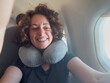 © Юлия Завалишина - Happy passenger young woman is flying in plane. Smiling girl sitting in airplane near window going on trip vacation travel. Traveling female inside plane enjoying flight. Traveling girl