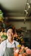 © Rawpixel.com - photo of local flower shop and asian man happy owner in front.