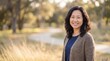 © JONATHAN - Smiling woman standing outdoors in golden light