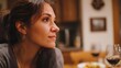 © Bussakon - A thoughtful woman viewed in profile during a warm intimate moment at a cozy dinner table