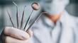 © dmmarychev - Professional dental instruments in hand of dentist wearing white gloves