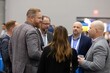 © Juan - Business professionals networking at corporate event discussing ideas collaboration and building strong professional relationships