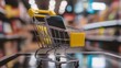 © Henry - E commerce concept with shopping cart and mobile phone on checkout counter in store
