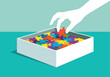 © razina01 - Hand placing a red puzzle piece into a box filled with colorful jigsaw pieces, concept of problem solving and finding the right solution
