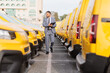 © Ljupco Smokovski - Manager inspecting a fleet of yellow delivery vans