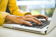 © MIND AND I - Close-Up of Businesswoman Hands Typing on Laptop Keyboard at Desk
