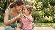 © TCyamauti - Mother and daughter practicing yoga and making shapeheart with hands, wellness lifestyle, Mother's Day