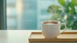 © Po - wellness nutrition mental concept. Steaming hot cup of tea on a wooden tray with a blurred background.