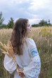 © Anna - Adult beautiful girl in a traditional embroidered shirt in a natural environment. Support Ukraine. Young generation of Ukrainians. National identity