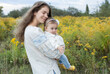 © Anna - young mom holds a sweet baby girl in her arms, both wearing traditional embroidered blouses. We are Ukrainians. Mother's Day. Independence Day of Ukraine. Motherly love and support