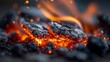 © www.freund-foto.de - Brennende Holzkohle mit orangefarbenen Flammen in einer dunklen, dramatischen Nahaufnahme