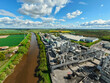 © AmazingAerialAgency - Aerial view of the Sedamyl Industrial Factory complex with large silos and pipes situated along the river under a blue sky with white clouds in Selby, England, United Kingdom.