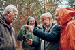 © Davor - Senior friends using smartphone for directions on forest trail
