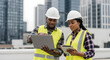 © DEXTEROUA - Group of African American engineer worker working in sewer pipes area at construction site. Male engineer and woman engineer work with laptop computer for maintenance sewer pipes, water tank