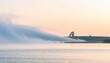 © NayaiP - Brume matinale sur un lac tranquille avec arbres lointains et ciel pastel au lever du soleil
