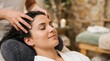 © Eve - Smiling young woman enjoying relaxing scalp massage in beauty spa salon. Professional wellness procedure for health, relaxation and stress management with copy space.