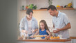 © Wosunan - Family bonding moment in the kitchen as parents and daughter bake together