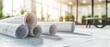 © GoStudio - Rolled architectural blueprints and technical drawings on white desk in modern office. Engineering planning, construction project and real estate development concept.
