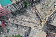 © AmazingAerialAgency - Keraniganj, Bangladesh - 11 April 2026: Aerial view of a busy bridge bisecting a sprawling landfill, a grim landscape of waste contrasting with human passage.