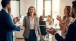 © Tanakorn - Joyful businesswoman receiving appreciation and handshake from colleagues during team celebration for professional achievement and career success in modern office