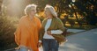 © dsheremeta - Senior women friends conversing walking outdoors in autumn