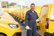 © Ljupco Smokovski - Mechanic with a fleet of yellow delivery vans