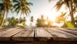 © dinda - Rustic Wooden Table with Tropical Palm Trees and Golden Sunset.