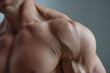 © Marut - Male torso with defined shoulder and subtle muscle contraction under soft lighting, close up showing skin texture and stubble