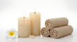 © MDGOLAM - Spa setting with lit candles rolled towels a flower relaxation wellness fragrance tranquility pampering lifestyle