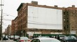 © AhmadFaris - Mockup of a large blank billboard on an old city building