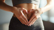 © Nova Zigres - Woman making a heart shape with her hands on her belly