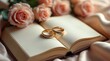 © Brutyse - Gold wedding rings on open book with pink roses background