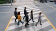 © Bussakon - Diverse group of professionals walking together across a city crosswalk symbolizing collabo n and the journey toward a common objective