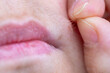 © kittyfly - Close-up fingers plucking facial hair near lips, single hair being removed, skin texture visible, personal care body maintenance, intimate self-grooming moment, dermatological detail, hygiene routine