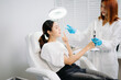 © Nuttapong punna - Doctor consulting patient in beauty clinic with facial analysis and skincare planning. Professional aesthetic treatment, clean sterile care, modern dermatology for radiant skin.
